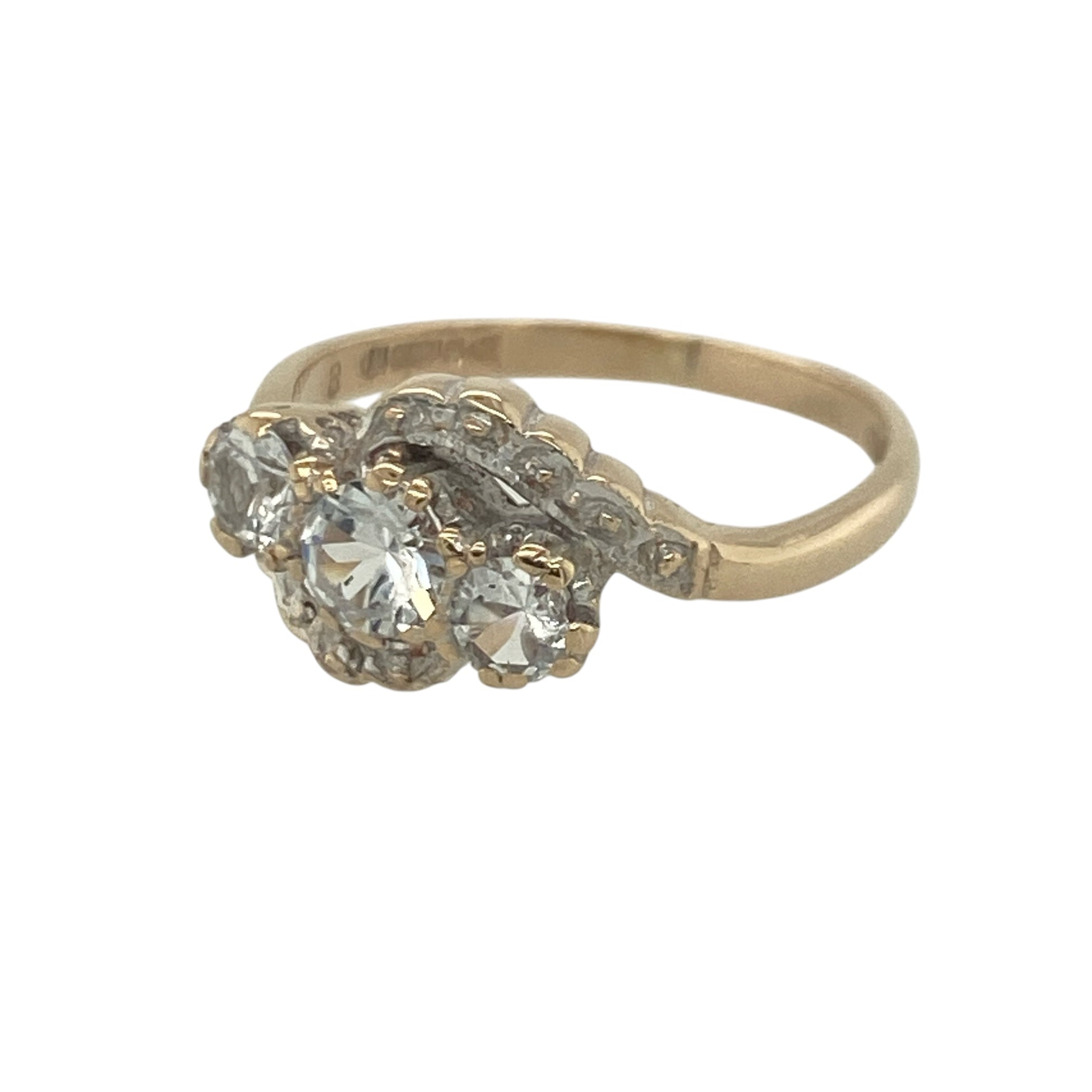 Add a touch of sparkle and elegance to your jewellery collection with this pre-owned 9ct yellow and white gold cubic zirconia twist trilogy ring, featuring a sophisticated two-tone design with timeless appeal—perfect for special occasions, gifting, or everyday wear.

Design: The ring showcases a beautiful trilogy arrangement centred around a striking round cubic zirconia measuring approximately 4mm in diameter.