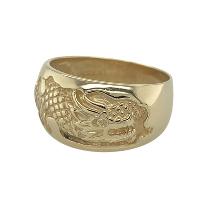 Make a bold statement with this pre-owned 9ct yellow gold dragon band ring, featuring an impressive mythical design with striking detail and timeless appeal—perfect for collectors, fantasy enthusiasts, or anyone seeking a distinctive piece of jewellery.

Design: The ring showcases an intricate dragon-themed design across a wide band measuring approximately 12mm at the front.