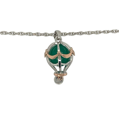 Celebrate adventure, freedom, and imagination with this pre-owned Clogau hot air balloon pendant necklace in sterling silver and 9ct rose gold. Featuring a vibrant green stone and an intricately detailed hot air balloon design, this distinctive necklace is a charming addition to any Clogau jewellery collection.

Design: The pendant showcases a beautifully detailed hot air balloon motif, symbolising aspiration, exploration, and new journeys.