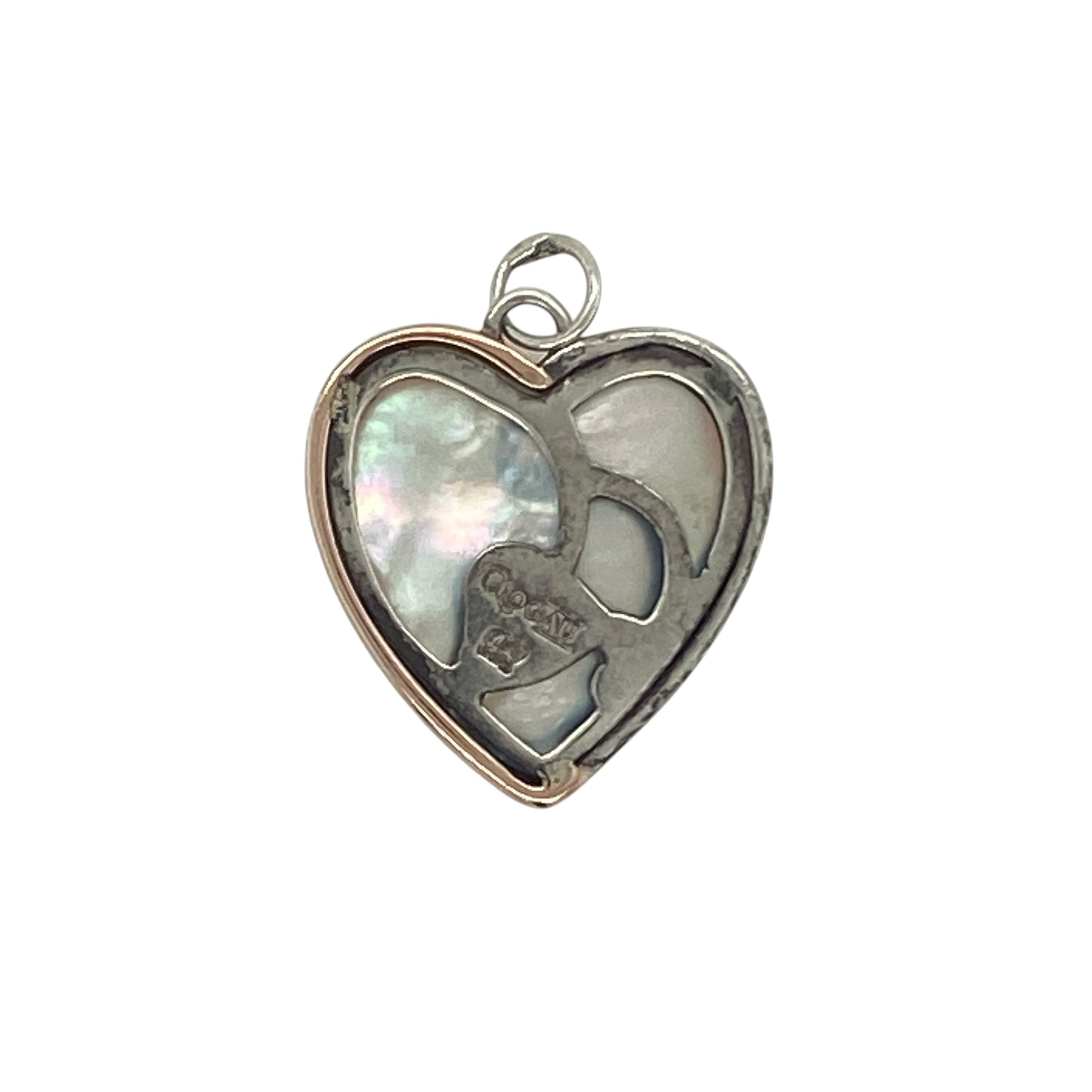 Celebrate love and timeless elegance with this pre-owned Clogau heart pendant in sterling silver and 9ct rose gold. Featuring a beautiful mother of pearl heart centre, this charming pendant combines soft iridescent tones with the distinctive Welsh-inspired style that makes Clogau jewellery so sought after.

Design: The pendant showcases a classic heart motif centred with a mother of pearl heart, creating a romantic and feminine design that symbolises love, affection, and treasured memories.