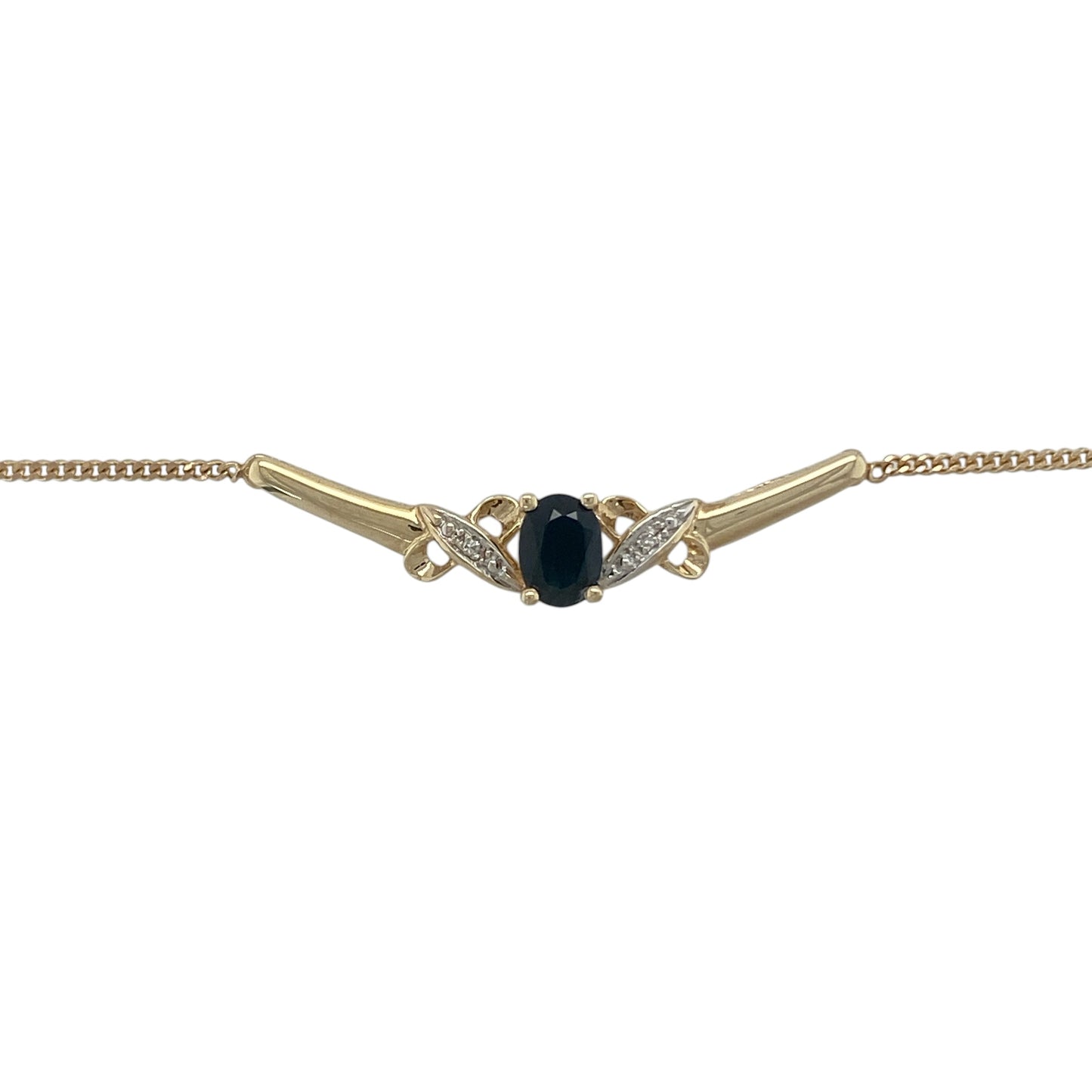 Add timeless elegance and vibrant colour to your jewellery collection with this pre-owned 9ct yellow gold diamond and sapphire necklace. Featuring a beautiful oval sapphire framed by sparkling diamonds on a graceful curved bar design, this sophisticated necklace is perfect for both everyday wear and special occasions.

Design: The necklace showcases an elegant curved bar centrepiece featuring an oval-cut sapphire measuring approximately 7mm by 5mm.