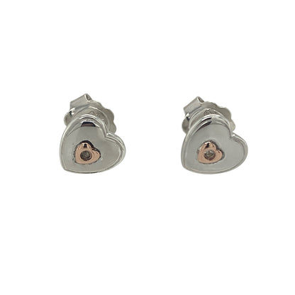 Add a touch of romance and Welsh-inspired elegance to your jewellery collection with these pre-owned 925 silver and 9ct rose gold Clogau white topaz heart stud earrings. Featuring the timeless heart motif enhanced by sparkling white topaz and signature rose gold detailing, these beautiful earrings are perfect for everyday wear or gifting to someone special.

Design: The earrings showcase an elegant heart-shaped design, combining polished sterling silver with contrasting 9ct rose gold accents.