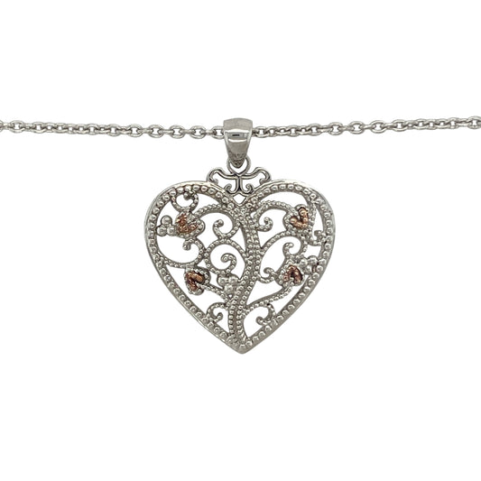 Celebrate love, family, and Welsh heritage with this pre-owned 925 silver and 9ct rose gold Clogau Tree of Life heart pendant necklace. Combining the iconic Tree of Life motif with a timeless heart design, this elegant necklace carries meaningful symbolism while offering versatile everyday style.

Design: The pendant showcases a beautiful heart-shaped design incorporating Clogau's renowned Tree of Life motif.