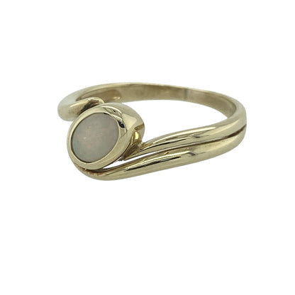 Add a touch of iridescent beauty to your jewellery collection with this pre-owned 9ct yellow gold Opalique twist ring. Featuring a graceful twist design and a shimmering Opalique centre stone, this elegant ring offers timeless style with a contemporary flair.

Design: The ring showcases a beautiful twist setting that gracefully frames an oval Opalique stone measuring approximately 6mm by 4mm.