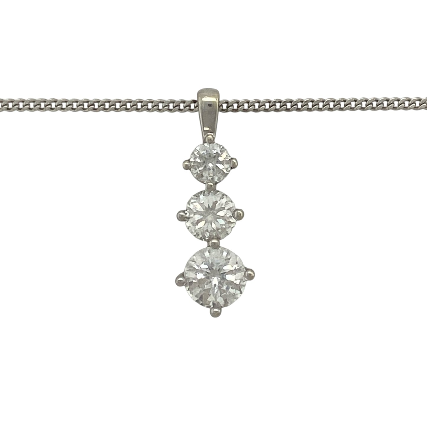 Add elegant sparkle and contemporary style to your jewellery collection with this pre-owned 9ct white gold cubic zirconia three stone drop pendant necklace. Featuring a graceful vertical arrangement of sparkling stones, this eye-catching piece offers timeless sophistication for both everyday wear and special occasions.

Design: The pendant showcases three cubic zirconia stones arranged in an elegant drop formation, creating movement and brilliance as they catch the light.