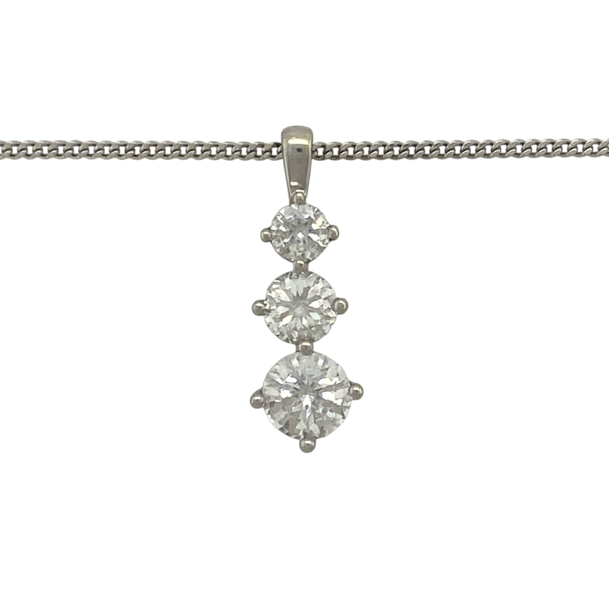 Add elegant sparkle and contemporary style to your jewellery collection with this pre-owned 9ct white gold cubic zirconia three stone drop pendant necklace. Featuring a graceful vertical arrangement of sparkling stones, this eye-catching piece offers timeless sophistication for both everyday wear and special occasions.

Design: The pendant showcases three cubic zirconia stones arranged in an elegant drop formation, creating movement and brilliance as they catch the light.