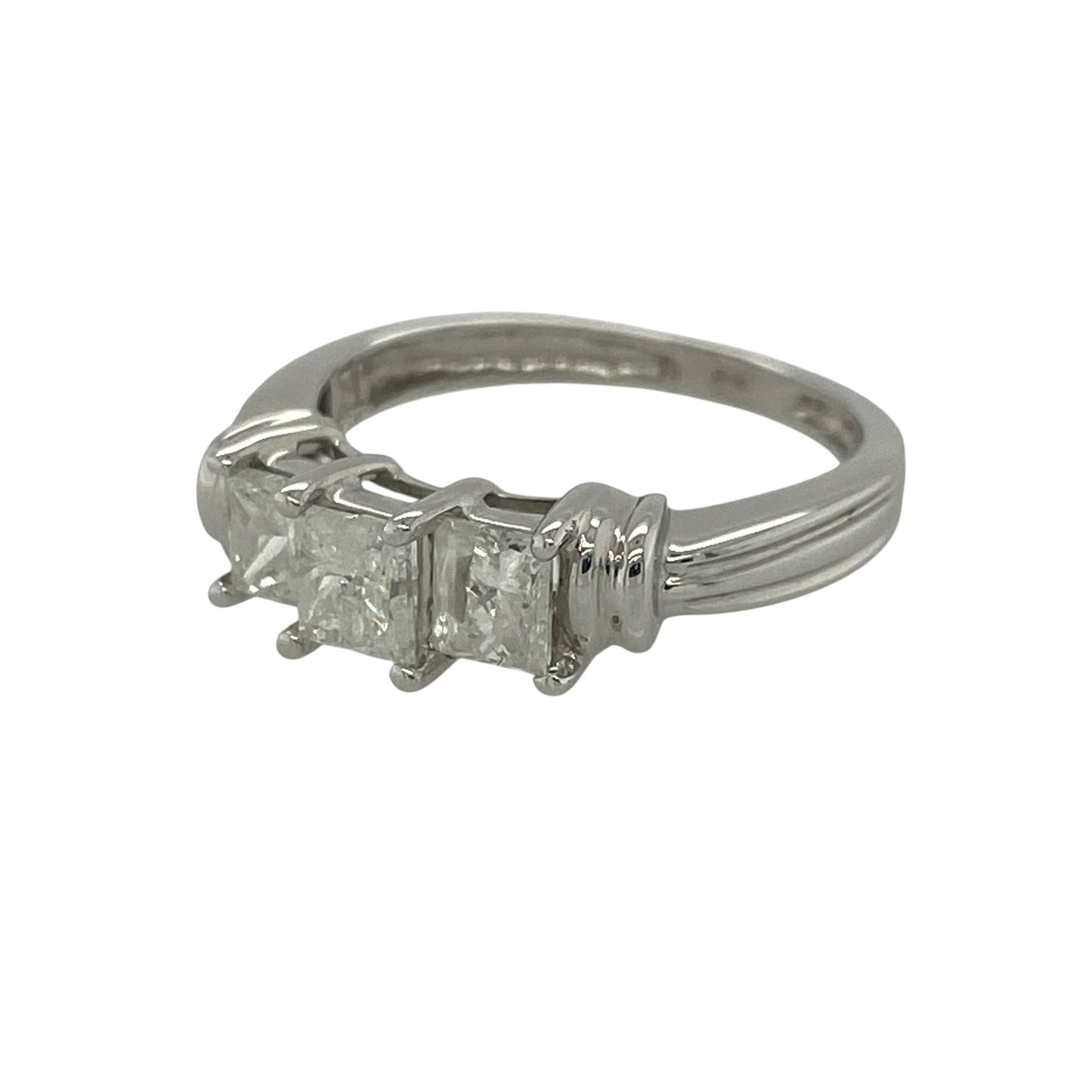 Make a statement with this pre-owned 14ct white gold princess cut diamond trilogy ring. Showcasing three impressive princess-cut diamonds with a substantial total diamond weight, this elegant ring combines contemporary styling with timeless symbolism.

Design: The ring features a classic trilogy arrangement of princess-cut diamonds, creating a sophisticated and eye-catching display. The clean geometric lines of the square-cut diamonds offer a modern appearance while maximising brilliance and sparkle.