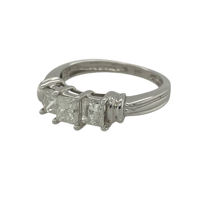 Make a statement with this pre-owned 14ct white gold princess cut diamond trilogy ring. Showcasing three impressive princess-cut diamonds with a substantial total diamond weight, this elegant ring combines contemporary styling with timeless symbolism.

Design: The ring features a classic trilogy arrangement of princess-cut diamonds, creating a sophisticated and eye-catching display. The clean geometric lines of the square-cut diamonds offer a modern appearance while maximising brilliance and sparkle.