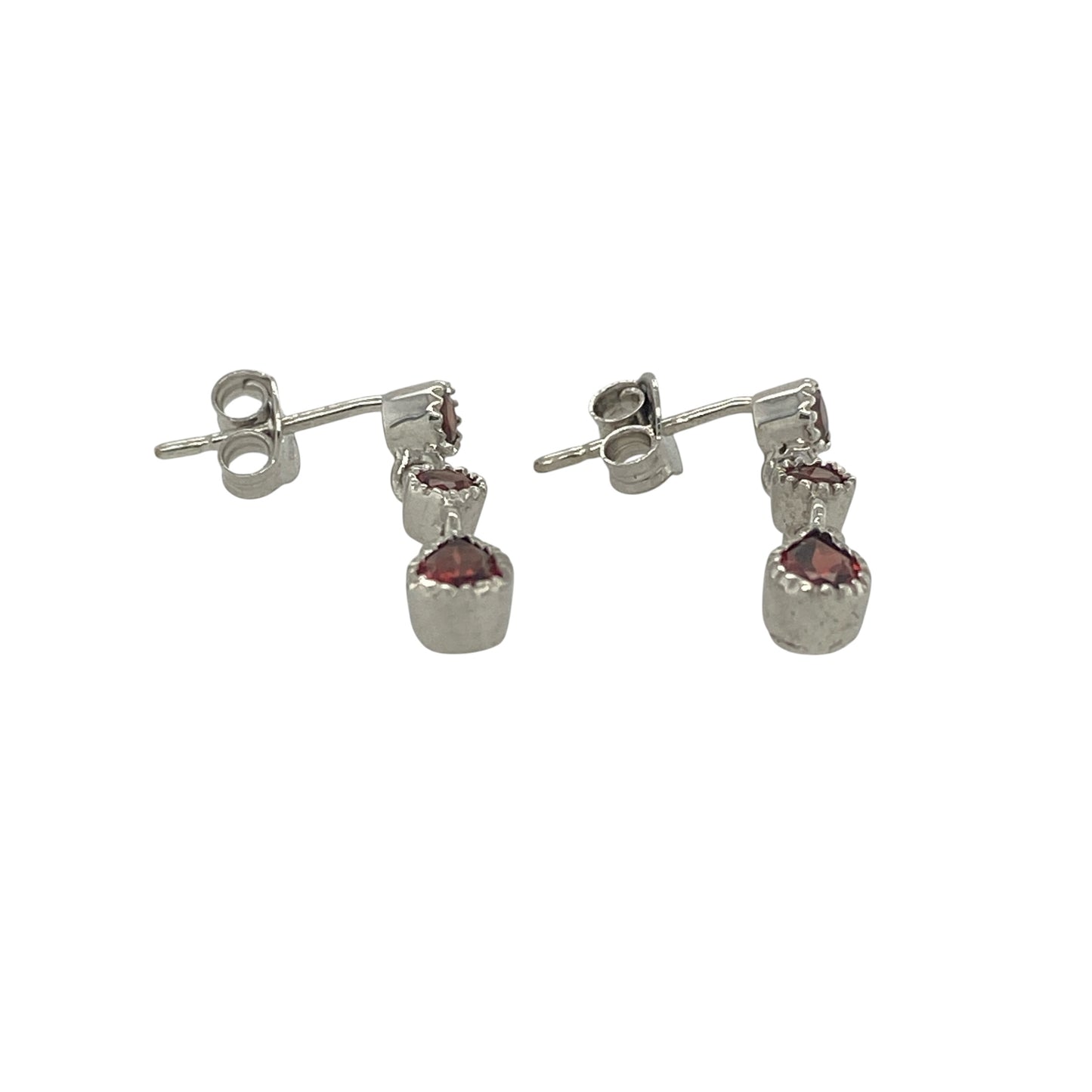 Add a touch of rich colour and elegant movement to your jewellery collection with these pre-owned 9ct white gold three-stone garnet drop earrings. Featuring beautifully matched garnets suspended in a graceful drop design, these earrings offer timeless sophistication and striking visual appeal.

Design: The earrings showcase a classic drop style, each set with three garnet gemstones arranged in a flowing vertical design.