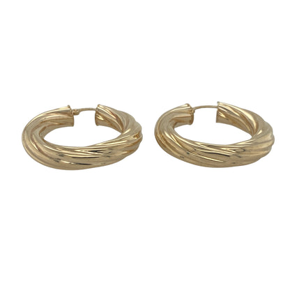 Make a stylish statement with these pre-owned 9ct yellow gold twisted hoop creole earrings. Featuring a classic hoop silhouette enhanced by elegant twisted detailing, these substantial earrings offer timeless appeal and excellent everyday versatility.

Design: The earrings showcase a traditional hoop creole design with a beautifully twisted profile. The flowing twist adds depth and texture to the gold, creating a striking effect as the earrings catch and reflect the light from different angles.
