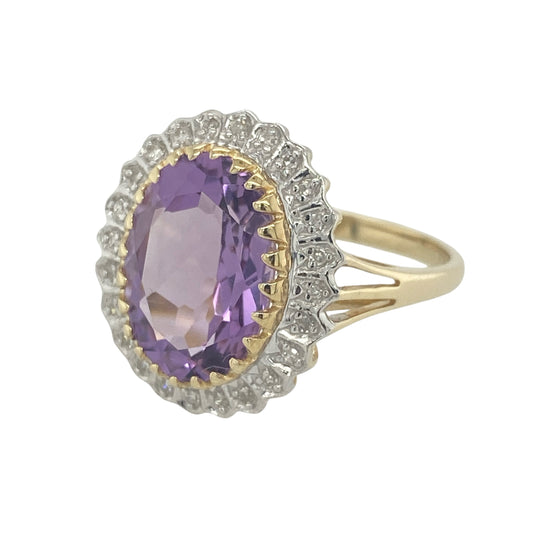 Striking and elegant, this pre-owned 9ct yellow gold diamond and amethyst cluster ring showcases a stunning large amethyst surrounded by sparkling diamonds. Combining rich colour, exceptional presence, and timeless styling, this ring is a true statement piece.

Design: The ring features a classic cluster design centred around a magnificent oval amethyst, framed by a halo of sparkling diamonds.