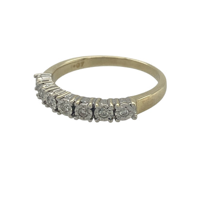 Elegant and timeless, this pre-owned 9ct yellow gold seven stone diamond band ring offers classic sparkle in a refined and wearable design. Featuring seven illusion-set diamonds across the front, this ring is perfect for everyday wear or as a meaningful gift for a special occasion.

Design: The ring features a traditional seven stone band design, with the diamonds arranged across the front of the ring to create a continuous line of sparkle.