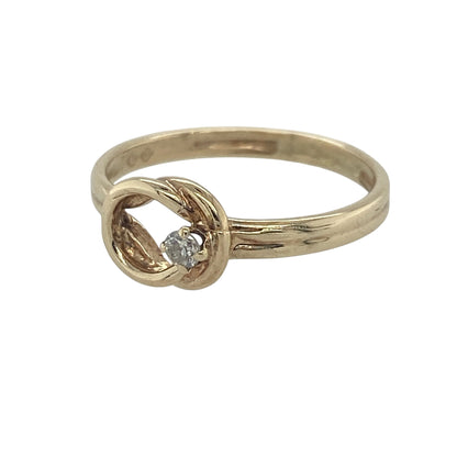 Elegant and symbolic, this pre-owned 9ct yellow gold diamond open knot ring beautifully combines timeless design with delicate sparkle. The graceful open knot motif represents unity, love, and everlasting connection, making it a meaningful addition to any jewellery collection.

Design: The ring features an attractive open knot design, creating a flowing and elegant silhouette. Measuring approximately 7mm in height across the front, the knot forms a graceful focal point that is both refined and eye-catching.