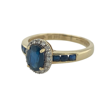 Elegant and beautifully detailed, this pre-owned 9ct yellow gold diamond and sapphire cluster ring is a timeless design that showcases the rich beauty of sapphires alongside the brilliance of sparkling diamonds. With additional sapphire accents on the shoulders, this striking ring offers colour, sparkle, and classic sophistication.

Design: The ring features a stunning oval sapphire at its centre, surrounded by a halo of sparkling diamonds to create a traditional cluster design.