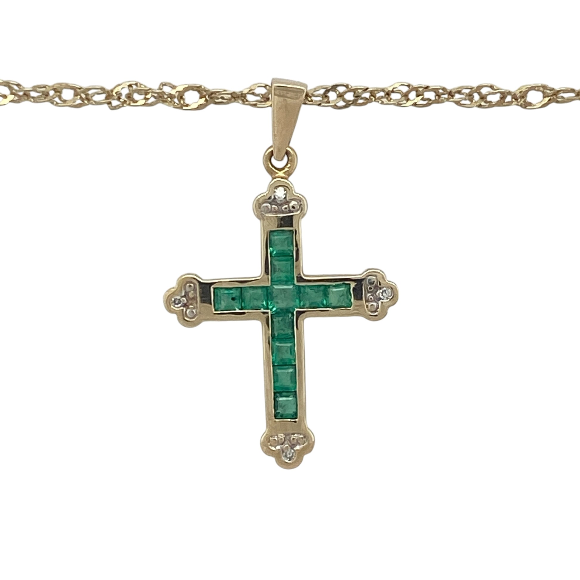 Elegant and meaningful, this pre-owned 9ct yellow gold diamond and emerald cross pendant necklace beautifully combines timeless Christian symbolism with the vibrant beauty of precious gemstones. Suspended from a classic Prince of Wales chain, it is a striking piece suitable for everyday wear or special occasions.

Design: The necklace features a beautifully crafted cross pendant measuring approximately 3.1cm in length, including the bail.