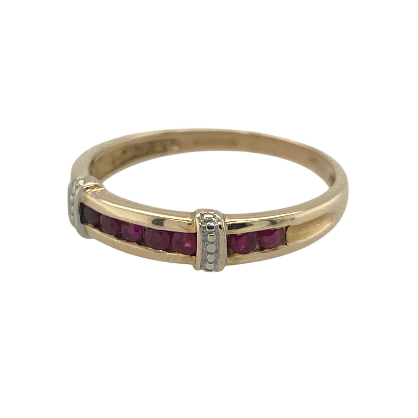 Elegant and timeless, this pre-owned 9ct yellow gold ruby band ring combines the rich colour of vibrant rubies with contrasting white gold shoulder detailing for a refined and distinctive finish. Its classic styling makes it a beautiful choice for everyday wear or as a meaningful gift.

Design: The ring features a classic gemstone band design with a row of rich red rubies set across the front.