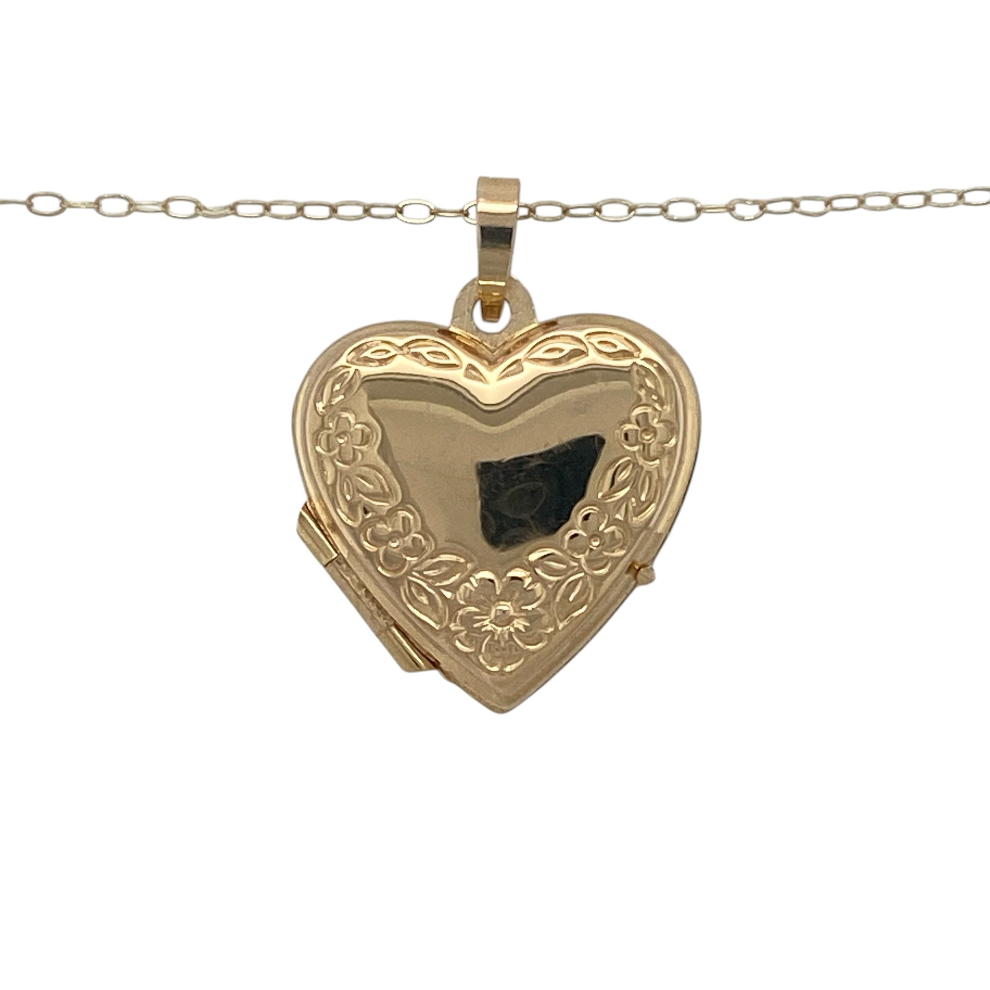 Romantic and timeless, this pre-owned 9ct yellow gold flower patterned heart locket necklace is a beautiful keepsake designed to hold treasured memories close. Featuring an elegant engraved floral design and suspended from a fine trace chain, it is a meaningful piece that will never go out of style.

Design: The necklace features a classic heart-shaped locket beautifully decorated with an intricate flower pattern on the front.