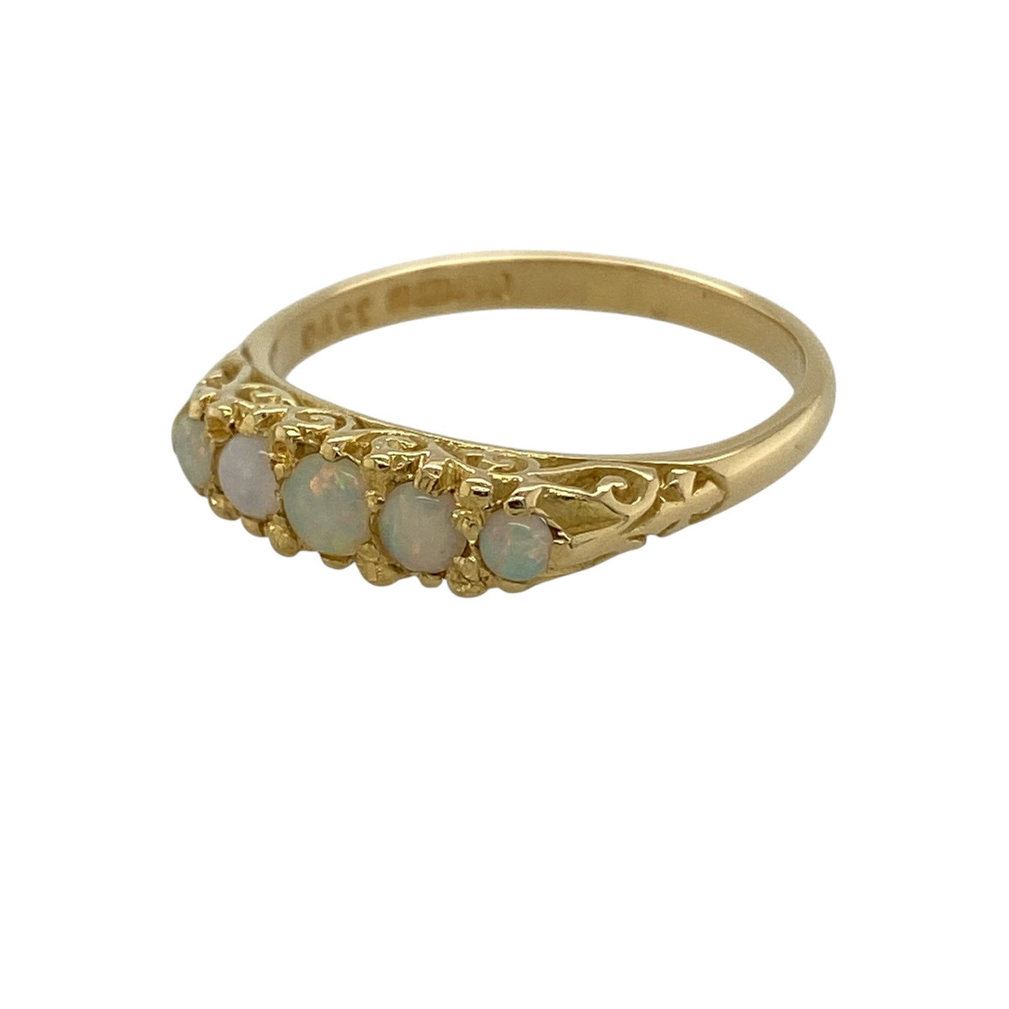 Bring classic elegance and beautiful natural colour to your jewellery collection with this pre-owned 18ct yellow gold five stone opal band ring, showcasing a timeless design with luminous opals—perfect for everyday wear or marking a special occasion.

Design: The ring features five round opal gemstones in a traditional five stone band arrangement, with the centre opal measuring approximately 3.5mm in diameter. The vibrant play of colour within the opals creates a captivating display from every angle.