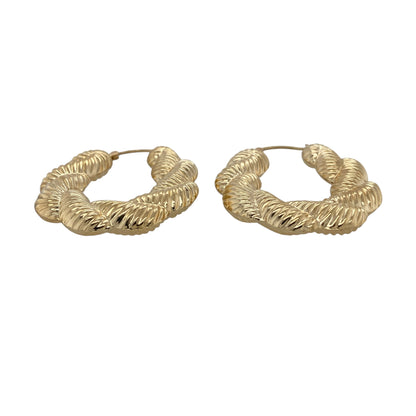 Make a statement with these pre-owned 9ct gold large plaited textured twisted oval Creole earrings, featuring an eye-catching combination of bold proportions and intricate detailing that brings timeless elegance to any jewellery collection.

Design: The earrings feature a large oval Creole hoop design with an attractive plaited, textured and twisted finish. The combination of detailed textures creates a striking light-catching effect, giving these earrings a bold yet sophisticated appearance.