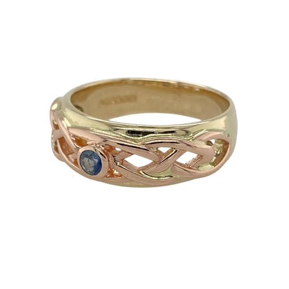 Bring rich colour and meaningful heritage to your collection with this pre-owned 9ct yellow and rose gold Clogau sapphire Celtic band ring—an elegant piece that blends traditional symbolism with classic gemstone beauty.

Design: The front of the band measures 7mm wide and features an intricate Celtic knot motif centred around a 3mm sapphire, adding a vibrant touch of blue. The flowing knotwork represents unity and continuity, giving the ring a timeless and expressive character.