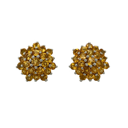 Add vibrant colour and timeless elegance to your jewellery collection with these pre-owned 9ct white gold citrine cluster stud earrings, featuring dazzling clusters of round citrine gemstones that create a bold and eye-catching look for any occasion.

Design: The earrings showcase impressive round clusters measuring approximately 15mm in diameter, each made up of multiple round citrine stones.