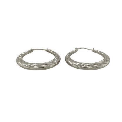 Add contemporary elegance to your jewellery collection with these pre-owned 9ct white gold twisted hoop creole earrings, featuring a timeless twisted design that catches the light beautifully and complements both everyday and occasion wear.

Design: The earrings feature a classic twisted hoop creole design, with the textured twist creating added depth and sparkle from every angle. Their elegant profile offers a modern take on a traditional hoop style.
