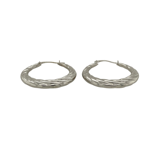 Add contemporary elegance to your jewellery collection with these pre-owned 9ct white gold twisted hoop creole earrings, featuring a timeless twisted design that catches the light beautifully and complements both everyday and occasion wear.

Design: The earrings feature a classic twisted hoop creole design, with the textured twist creating added depth and sparkle from every angle. Their elegant profile offers a modern take on a traditional hoop style.
