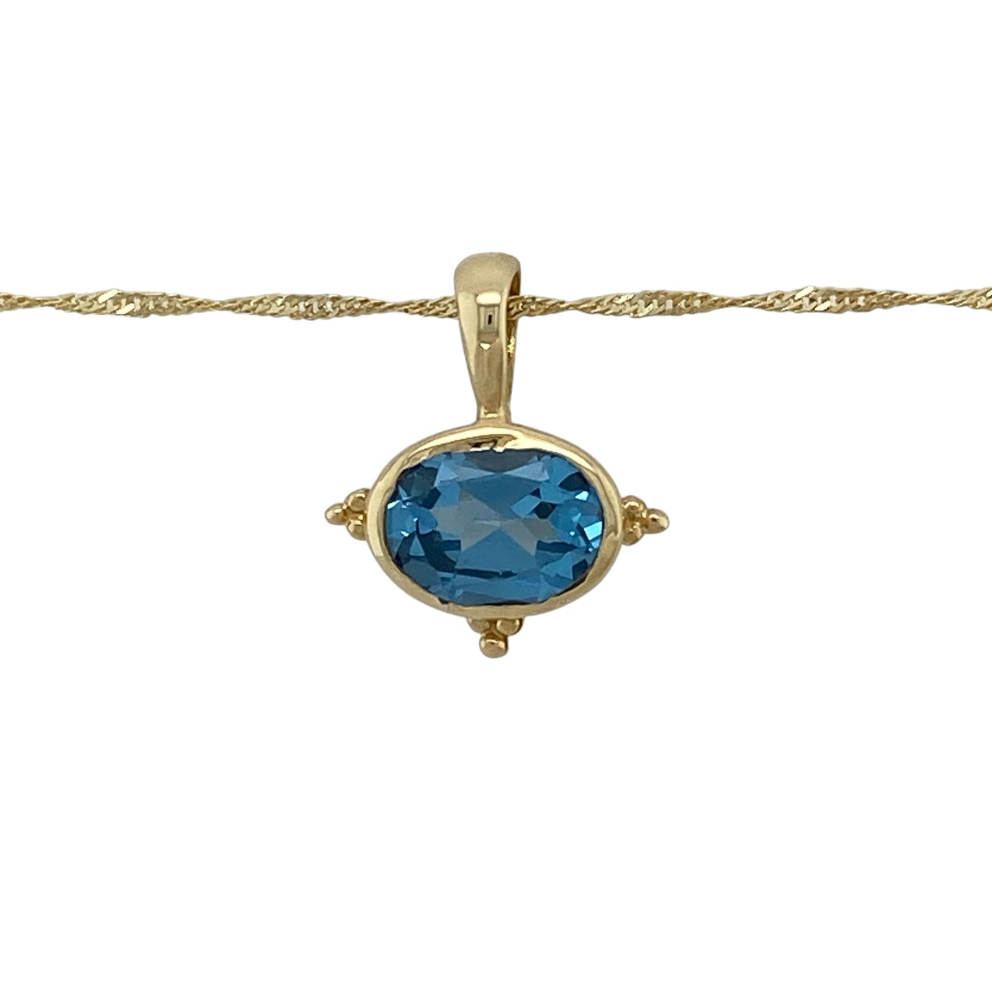 Add vibrant colour and timeless elegance to your jewellery collection with this pre-owned 14ct yellow gold blue topaz pendant necklace, featuring a stunning oval blue topaz suspended from a classic 20-inch Singapore chain.

Design: The necklace features a beautiful oval blue topaz measuring approximately 9mm by 7mm, creating a striking focal point with its vibrant sky-blue colour.