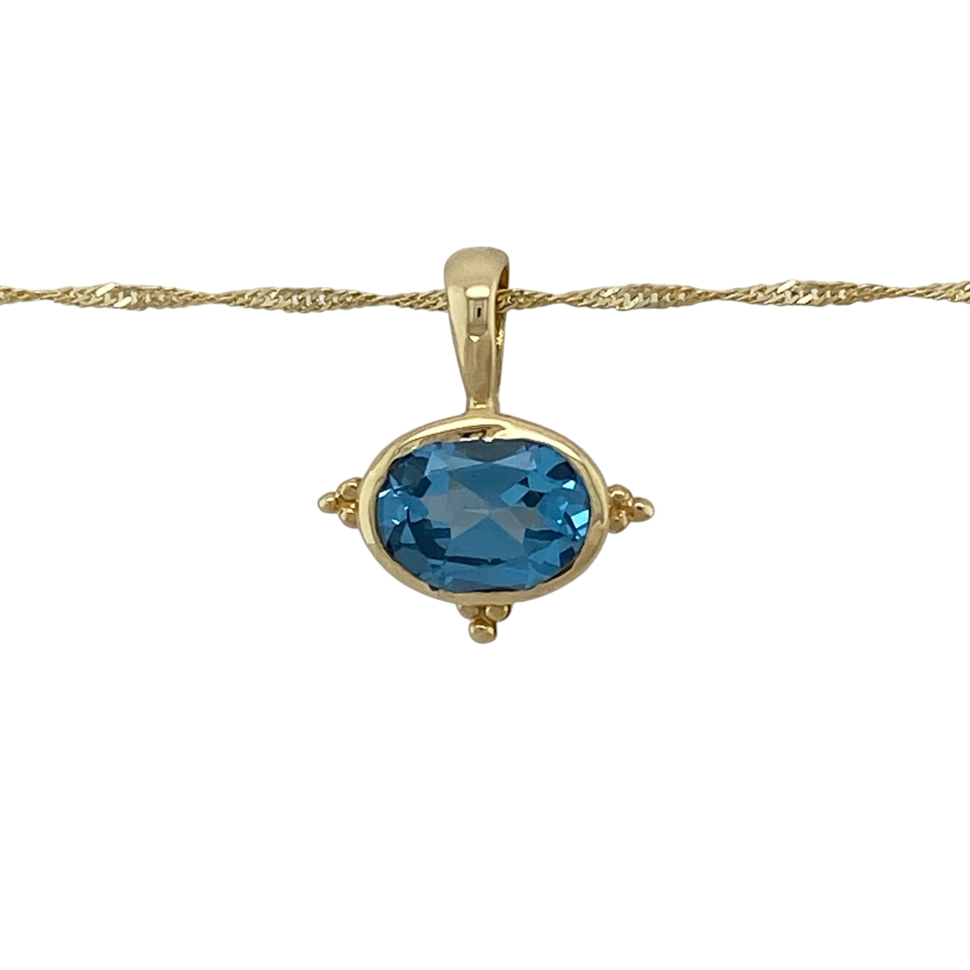 Add vibrant colour and timeless elegance to your jewellery collection with this pre-owned 14ct yellow gold blue topaz pendant necklace, featuring a stunning oval blue topaz suspended from a classic 20-inch Singapore chain.

Design: The necklace features a beautiful oval blue topaz measuring approximately 9mm by 7mm, creating a striking focal point with its vibrant sky-blue colour.