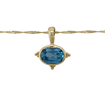 Add vibrant colour and timeless elegance to your jewellery collection with this pre-owned 14ct yellow gold blue topaz pendant necklace, featuring a stunning oval blue topaz suspended from a classic 20-inch Singapore chain.

Design: The necklace features a beautiful oval blue topaz measuring approximately 9mm by 7mm, creating a striking focal point with its vibrant sky-blue colour.