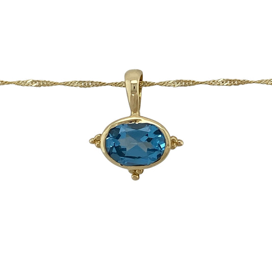 Add vibrant colour and timeless elegance to your jewellery collection with this pre-owned 14ct yellow gold blue topaz pendant necklace, featuring a stunning oval blue topaz suspended from a classic 20-inch Singapore chain.

Design: The necklace features a beautiful oval blue topaz measuring approximately 9mm by 7mm, creating a striking focal point with its vibrant sky-blue colour.