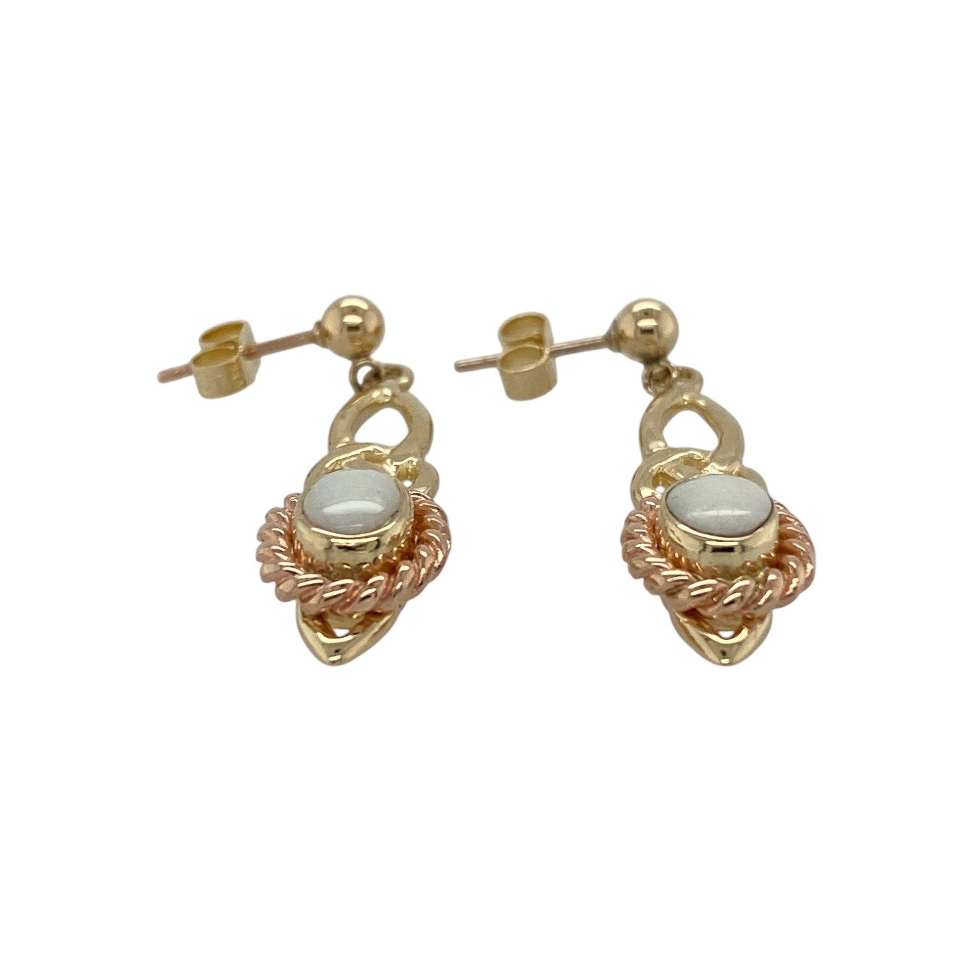 Celebrate Welsh heritage with these pre-owned 9ct yellow and rose gold Clogau Opalique Celtic drop earrings, featuring elegant Opalique gemstones surrounded by rope-style detailing in a timeless Celtic-inspired design.

Design: The earrings showcase beautiful oval Opalique stones measuring approximately 7mm by 5mm, each framed by an attractive rope-style surround.