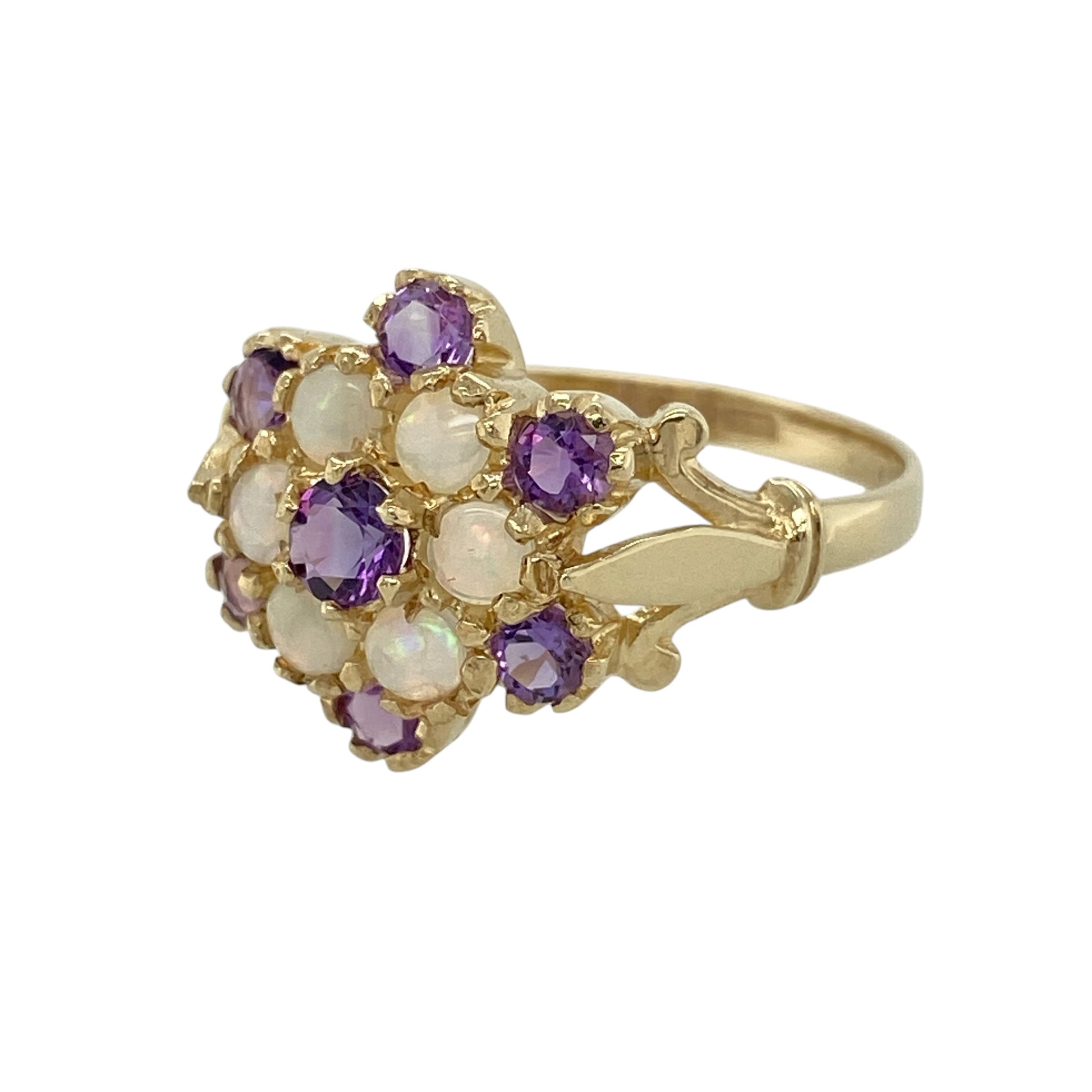 Add beautiful colour and vintage-inspired elegance to your jewellery collection with this pre-owned 9ct yellow gold amethyst and Opalique cluster ring, featuring a striking floral-inspired cluster design—perfect for special occasions or everyday wear.

Design: The ring showcases a beautiful cluster arrangement measuring approximately 14mm across the front, combining rich purple amethyst with shimmering Opalique stones to create a striking and elegant focal point.