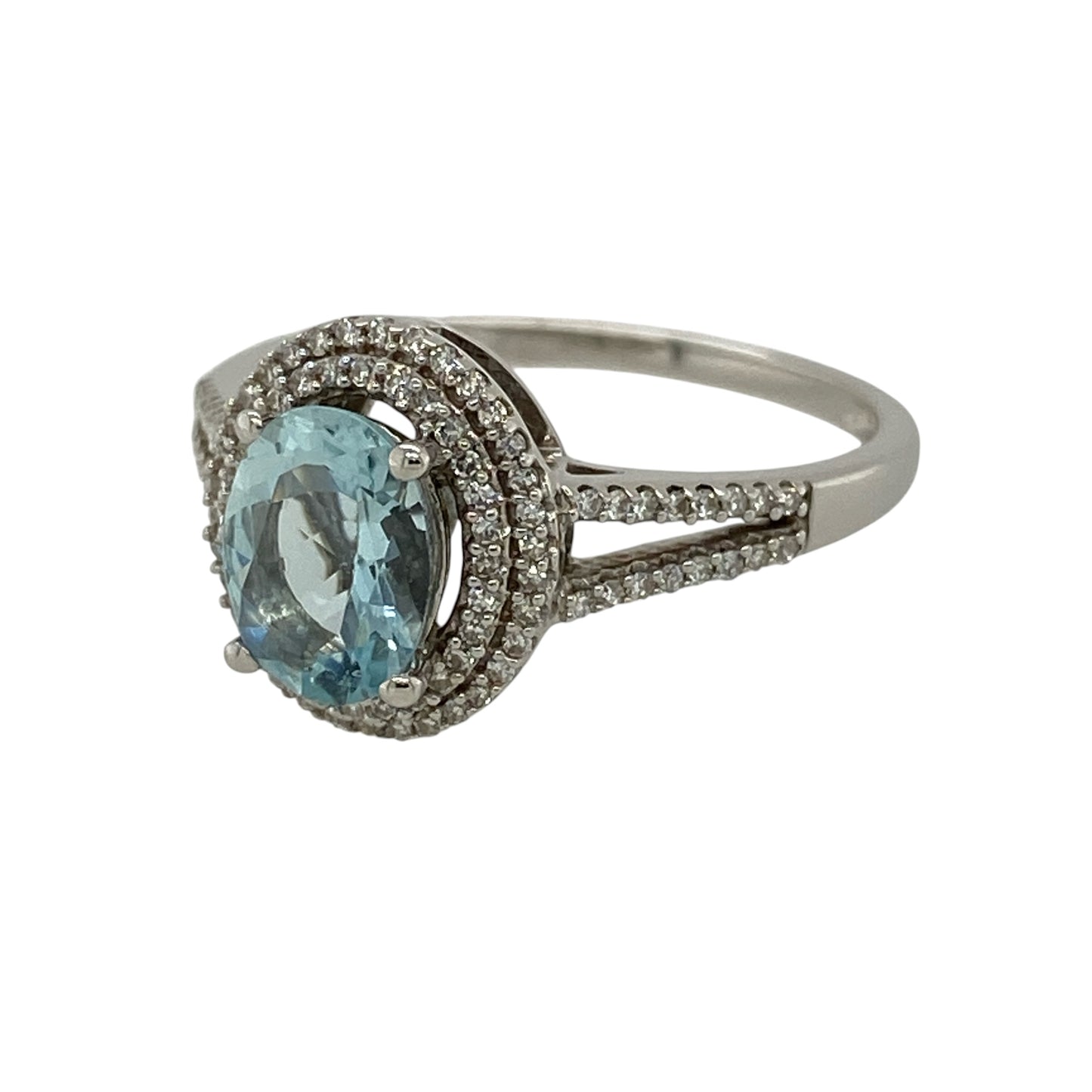 Add exceptional sparkle to your jewellery collection with this pre-owned 9ct white gold diamond and blue stone ring, featuring a striking oval blue centre stone framed by two rows of dazzling diamonds.

Design: The ring showcases a vibrant oval blue centre stone measuring approximately 8mm by 6mm, surrounded by a luxurious double halo of sparkling diamonds that enhance its brilliance and create an impressive statement.