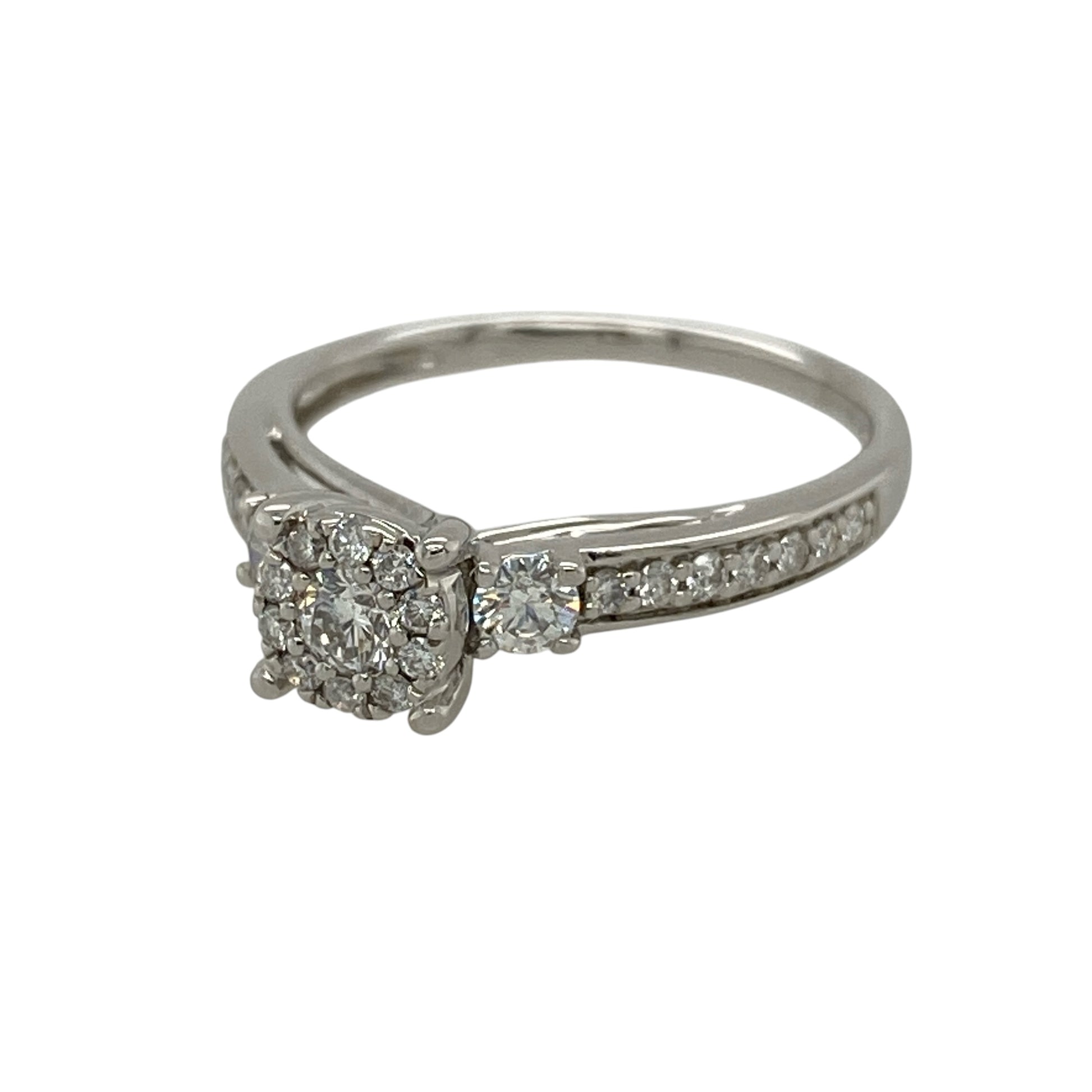 Add exceptional brilliance to your jewellery collection with this pre-owned 9ct white gold diamond cluster ring, featuring a sparkling central cluster enhanced by diamond-set shoulders for a luxurious finish.

Design: The ring showcases a dazzling central diamond cluster, beautifully framed by a single diamond on either side before flowing into elegant diamond-set shoulders.