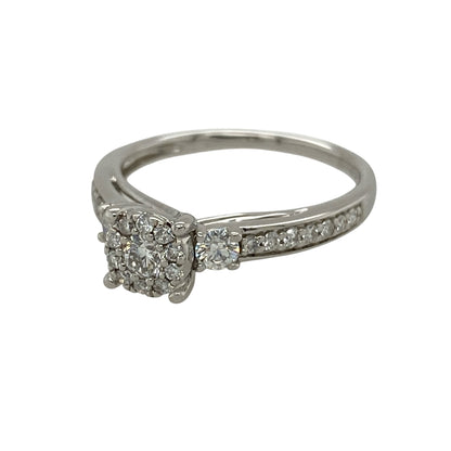Add exceptional brilliance to your jewellery collection with this pre-owned 9ct white gold diamond cluster ring, featuring a sparkling central cluster enhanced by diamond-set shoulders for a luxurious finish.

Design: The ring showcases a dazzling central diamond cluster, beautifully framed by a single diamond on either side before flowing into elegant diamond-set shoulders.