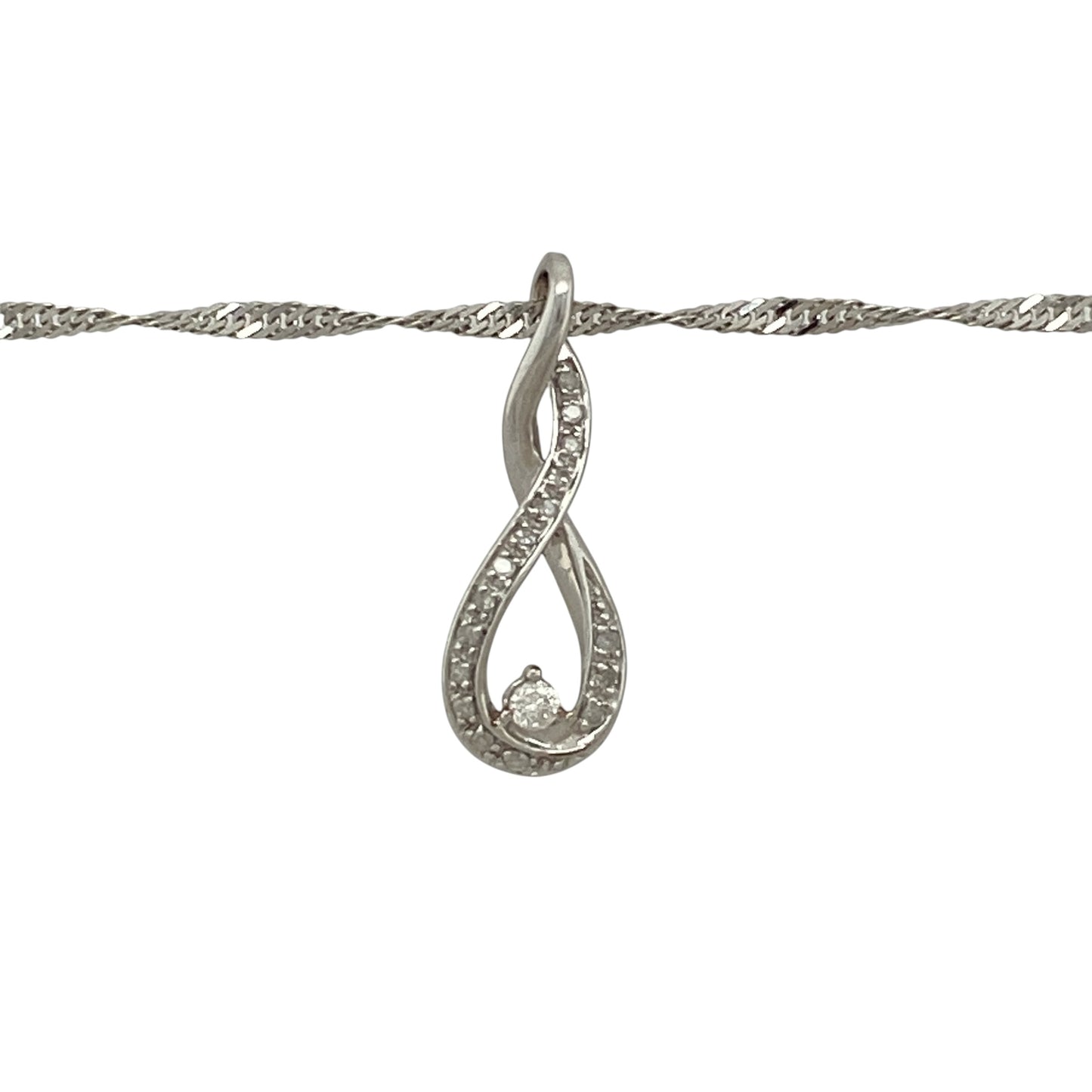 Add effortless elegance to your jewellery collection with this pre-owned 9ct white gold diamond twist pendant necklace, featuring a graceful flowing design suspended from a shimmering Singapore chain.

Design: The necklace showcases an elegant twist pendant, beautifully accented with sparkling diamonds that catch the light as the pendant curves gracefully.