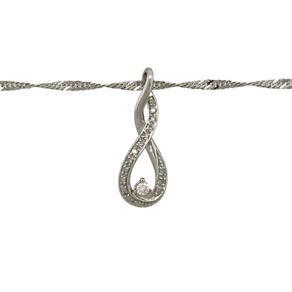 Add effortless elegance to your jewellery collection with this pre-owned 9ct white gold diamond twist pendant necklace, featuring a graceful flowing design suspended from a shimmering Singapore chain.

Design: The necklace showcases an elegant twist pendant, beautifully accented with sparkling diamonds that catch the light as the pendant curves gracefully.