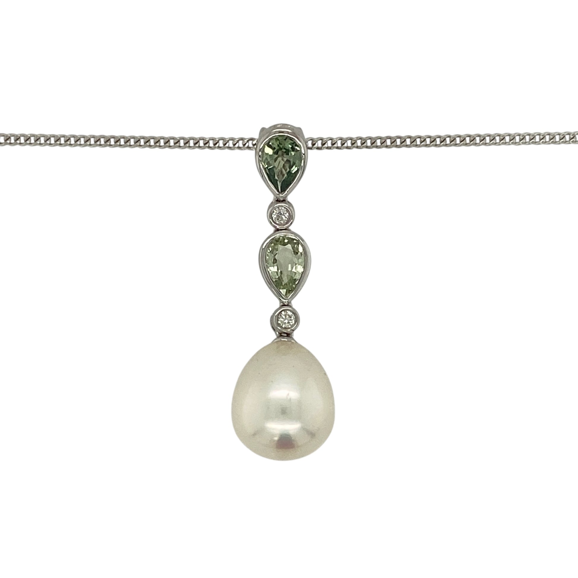 Make a sophisticated statement with this pre-owned 18ct white gold diamond, pearl and green stone pendant necklace, featuring an elegant combination of lustrous pearl, vibrant teardrop gemstones and sparkling diamond accents.

Design: The pendant showcases a beautiful lustrous pearl measuring approximately 13mm by 11mm, suspended beneath two elegant teardrop-shaped green stones, each measuring approximately 6mm by 4mm.