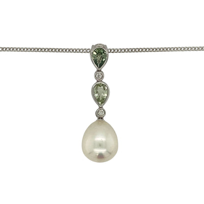 Make a sophisticated statement with this pre-owned 18ct white gold diamond, pearl and green stone pendant necklace, featuring an elegant combination of lustrous pearl, vibrant teardrop gemstones and sparkling diamond accents.

Design: The pendant showcases a beautiful lustrous pearl measuring approximately 13mm by 11mm, suspended beneath two elegant teardrop-shaped green stones, each measuring approximately 6mm by 4mm.