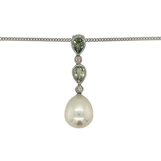 Make a sophisticated statement with this pre-owned 18ct white gold diamond, pearl and green stone pendant necklace, featuring an elegant combination of lustrous pearl, vibrant teardrop gemstones and sparkling diamond accents.

Design: The pendant showcases a beautiful lustrous pearl measuring approximately 13mm by 11mm, suspended beneath two elegant teardrop-shaped green stones, each measuring approximately 6mm by 4mm.