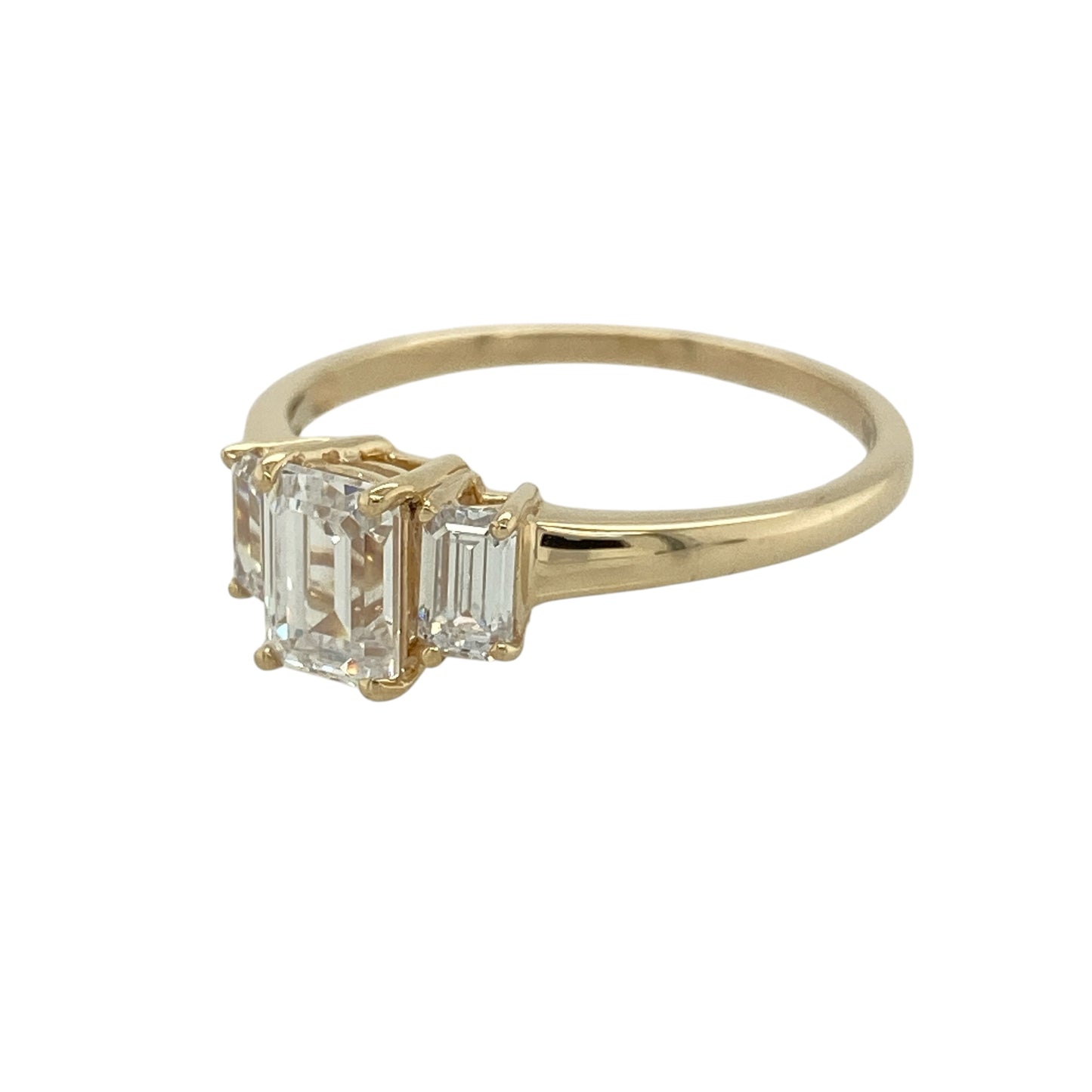 Add classic sparkle to your jewellery collection with this pre-owned 9ct yellow gold cubic zirconia trilogy ring, featuring three elegant stones in a timeless design.

Design: The ring showcases a striking rectangular centre cubic zirconia stone measuring approximately 7mm by 5mm, complemented by a stone on either side to create a classic trilogy arrangement. The three-stone design offers beautiful sparkle and an elegant presence on the finger, making it suitable for everyday wear or special occasions.