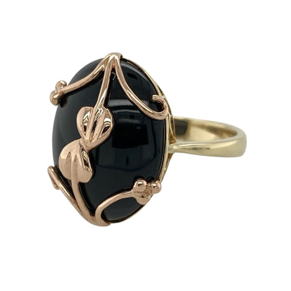 Celebrate Welsh heritage with this pre-owned 9ct yellow and rose gold Clogau Tree of Life ring, featuring a striking black onyx centrepiece beautifully engraved with the iconic Tree of Life vine motif.

Design: This elegant ring showcases a large oval black onyx stone measuring approximately 19mm by 14mm, creating a bold and sophisticated focal point.