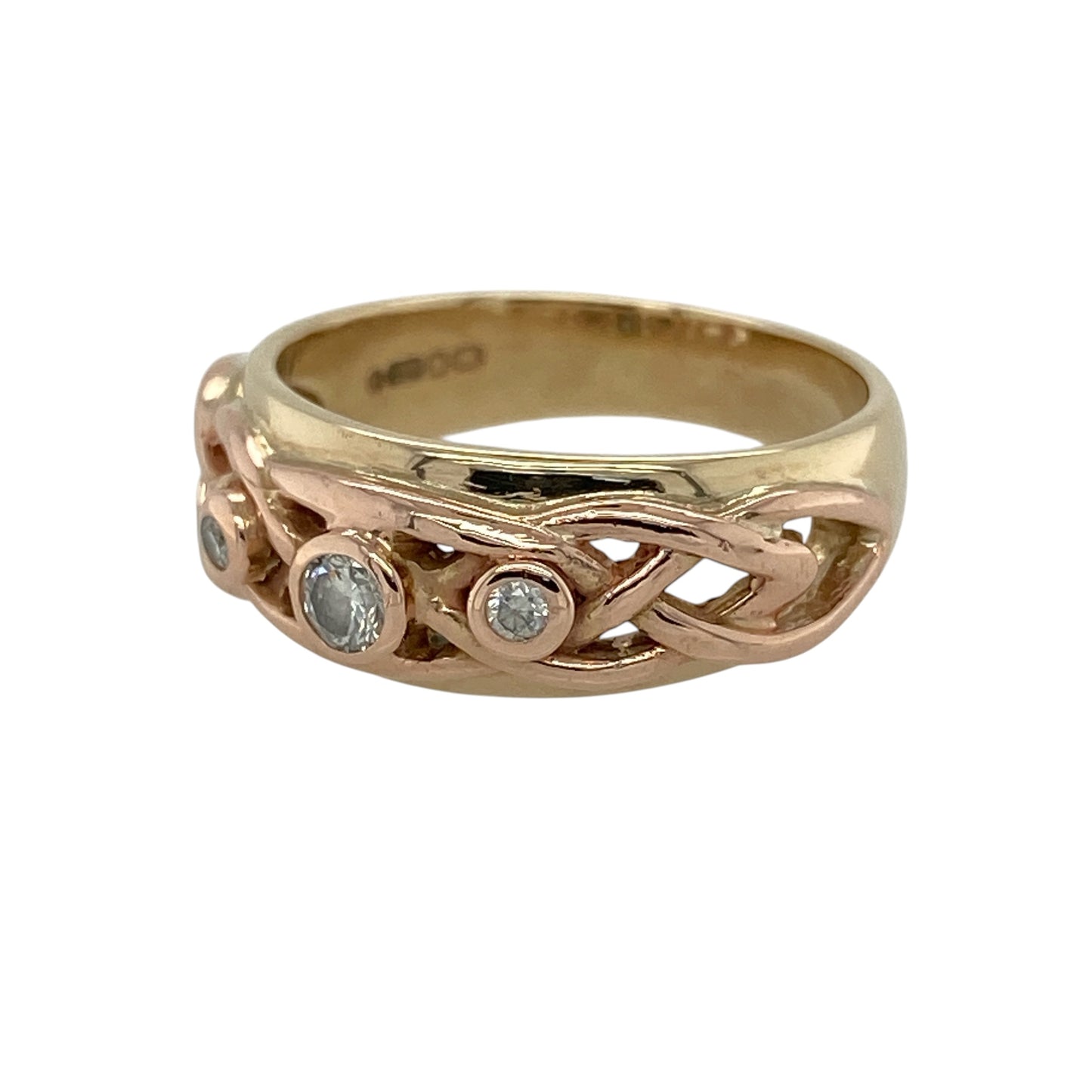 Celebrate Welsh heritage and timeless craftsmanship with this pre-owned 9ct yellow and rose gold diamond-set Clogau Trilogy Celtic Knot band ring, featuring an elegant two-tone design with meaningful Celtic symbolism.

Design: This striking band ring showcases Clogau's signature combination of yellow and rose gold, enhanced by an intricate Celtic knot motif and a sparkling trilogy of diamonds.