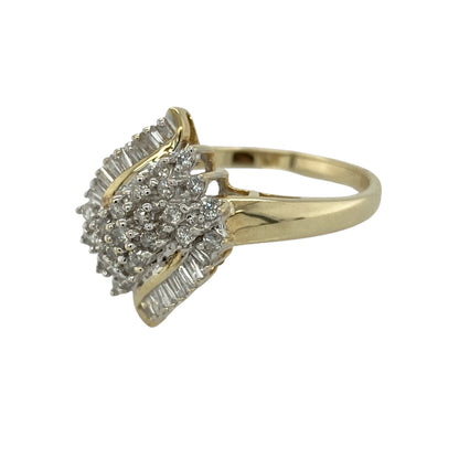 Make a striking statement with this pre-owned 9ct yellow gold diamond cluster ring, featuring an impressive arrangement of baguette and brilliant-cut diamonds in a bold and eye-catching design.

Design: The ring showcases a substantial diamond cluster composed of baguette and brilliant-cut diamonds, creating an impressive display of sparkle, dimension and contrasting shapes. 