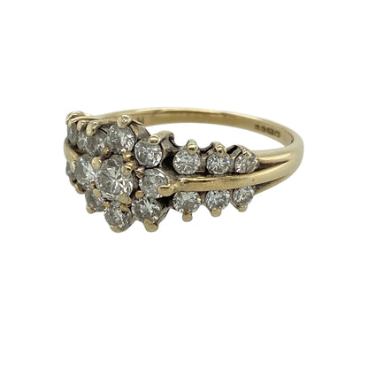 Add timeless sparkle and elegant detailing to your jewellery collection with this pre-owned 9ct yellow gold diamond cluster ring, featuring a brilliant-cut centre cluster and diamond-set shoulders.

Design: The ring showcases an eye-catching central cluster composed of brilliant-cut diamonds, creating a beautiful focal point with plenty of sparkle. Measuring approximately 10mm high across the front, the cluster offers a noticeable presence on the finger while maintaining a classic and wearable appearance.