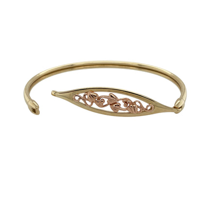 Add distinctive Welsh-inspired styling and timeless two-tone elegance to your jewellery collection with this pre-owned 9ct yellow and rose gold Clogau Tree of Life bangle, featuring the iconic flowing botanical motif associated with the collection.

Design: The bangle showcases the decorative Tree of Life design, featuring intricate flowing vines and leaves that create an eye-catching nature-inspired appearance.