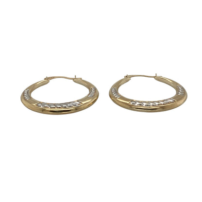 Add versatile two-tone styling and decorative detail to your jewellery collection with these pre-owned 9ct yellow and white gold patterned hoop creole earrings, featuring a classic design with an attractive textured finish.

Design: The earrings showcase a traditional hoop creole profile enhanced with decorative patterning, creating additional texture and visual interest.