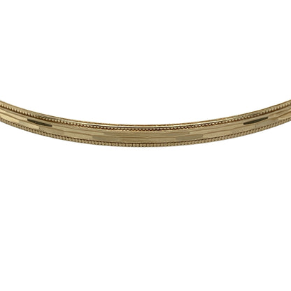 Add timeless elegance and decorative texture to your jewellery collection with this pre-owned 9ct yellow solid gold patterned bangle, featuring attractive detailing with refined milgrain edges.

Design: The bangle showcases a classic slim profile enhanced with decorative patterning and elegant milgrain edge detailing, creating texture and visual interest while retaining a timeless and versatile appearance.