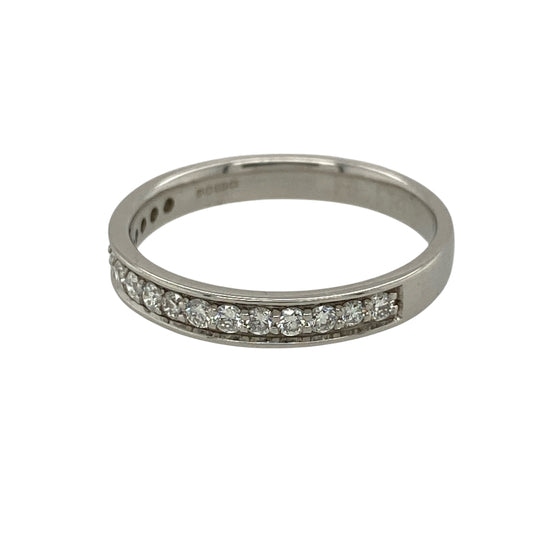 Add timeless elegance and refined sparkle to your jewellery collection with this pre-owned 18ct white gold and diamond half eternity style band ring, featuring a classic design set with seventeen brilliant cut diamonds.

Design: The ring showcases a traditional half eternity style design with a row of brilliant cut diamonds set across the front section of the band, creating an elegant line of sparkle and a timeless appearance suitable for everyday wear or special occasions.